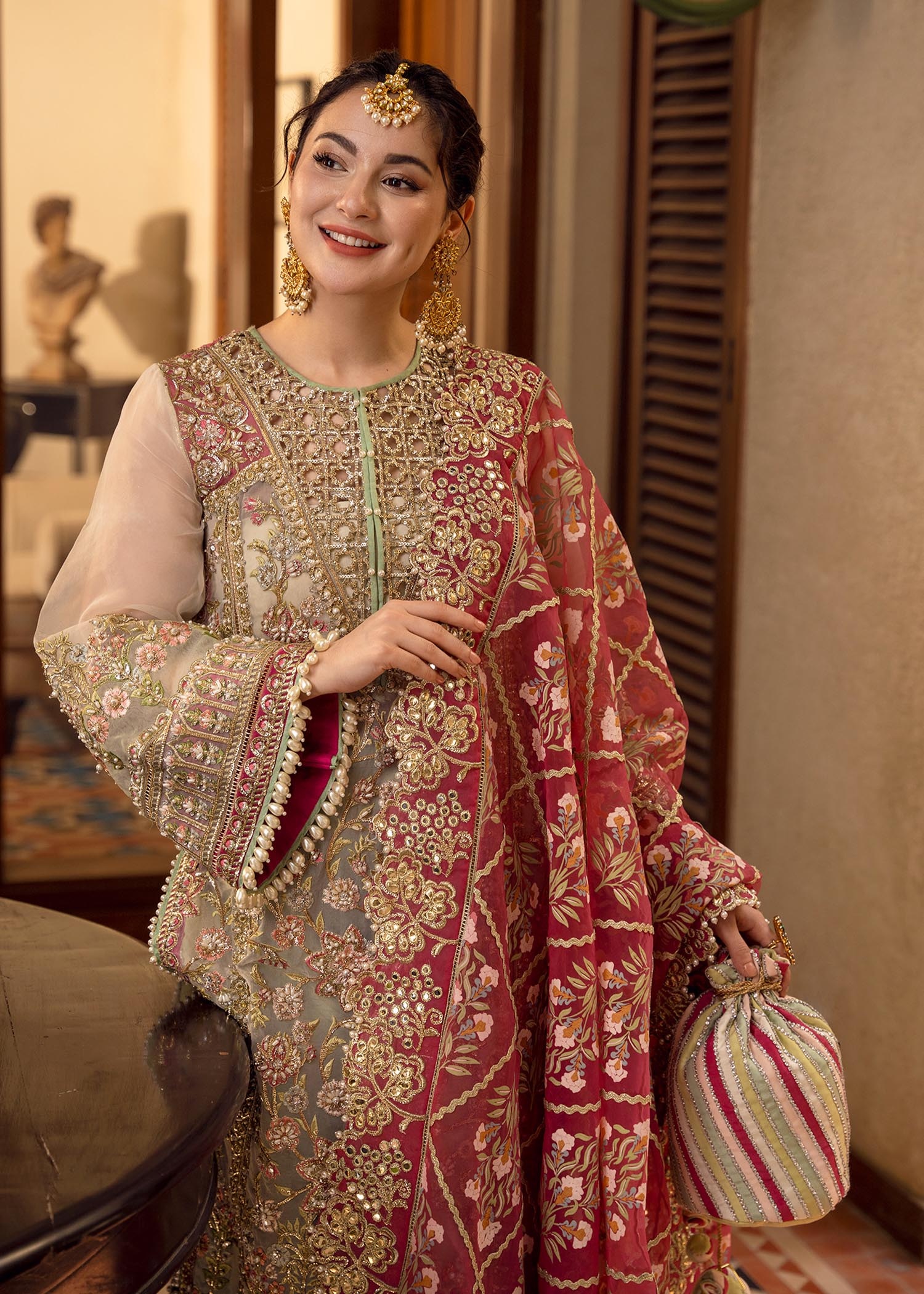 Artisanal Anecdotes Pakistani fashion outfit in gold, pink tones.